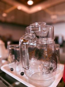 a row of glass jars sitting on a shelf at Sea Island Resort in Cheruvattūr