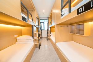 a dorm room with bunk beds in it at Dengba Inn-Shanghai New World Plaza Branch in Shanghai +14 photos