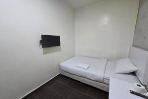 Postel nebo postele na pokoji v ubytování Fast Hotel Sri Gombak