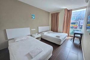 Postel nebo postele na pokoji v ubytování Fast Hotel Sri Gombak