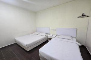 Postel nebo postele na pokoji v ubytování Fast Hotel Sri Gombak