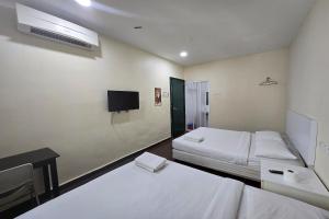 Postel nebo postele na pokoji v ubytování Fast Hotel Sri Gombak