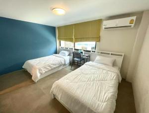 Voodi või voodid majutusasutuse Lachata Ramkhamhaeng Hotel 曼谷拉差塔酒店 toas