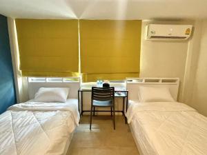 Voodi või voodid majutusasutuse Lachata Ramkhamhaeng Hotel 曼谷拉差塔酒店 toas