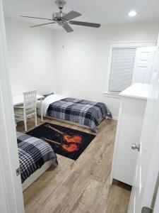 a bedroom with two beds and a ceiling fan at Vacation Unit is Available for Business and Family Trip in Long Beach