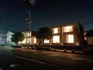 a building on a city street at night at The land hotel L5 in Arao +6 photos