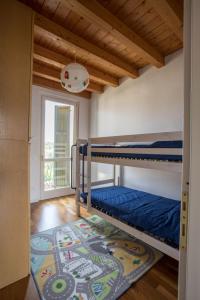 a room with two bunk beds and a rug at Wonderful villa on the Garda Lake with private garden in Salò