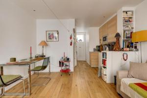 a kitchen and living room with a desk and a table at Historic paris charme in Paris