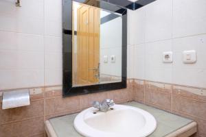 a bathroom with a sink and a mirror at RedDoorz at Savitri Hotel in Yogyakarta +67 photos