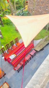 a group of tables and chairs with a large umbrella at BIRD HOUSE resort in Hữu Biêt +3 photos