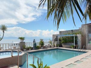 a swimming pool with a view of the ocean at Sunset Beach Resort in Moalboal