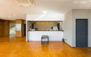 a room with a counter and a table in a building at Toyokawa Grand Hotel in Toyokawa