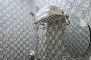 a bathroom with a shower with a mirror at AJ Residences Apartelle Camotes RedPartner in Esperanza +37 photos