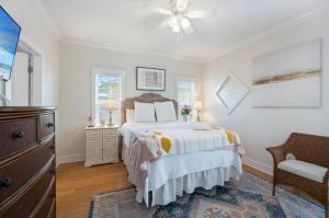 a bedroom with a bed and a ceiling fan at Captain's Chair 18A By Pkrm in Pensacola +33 photos