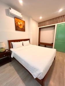 Ένα ή περισσότερα κρεβάτια σε δωμάτιο στο Saigon Holiday House