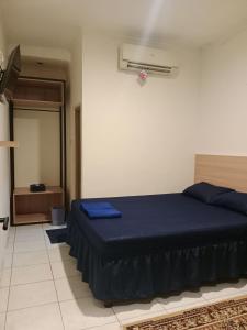 a bedroom with a blue bed in a room at Hotel Rimadi in Jakarta