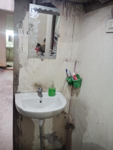 a bathroom with a sink and a mirror at Chauhans house in Prayagraj +2 photos