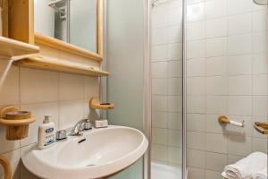 a bathroom with a sink and a shower at Appartamento Quota 1800 - Happy Rentals in Claviere