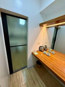 a room with a wooden counter and a glass door at 24-Seven Guesthouse - Room 202 in Catbalogan