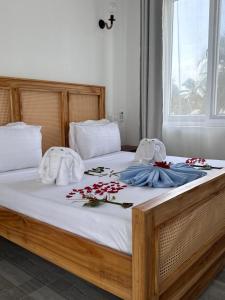 a bed with towels and flowers on top of it at Mia Boutique Hotel & Restaurant in Michamvi