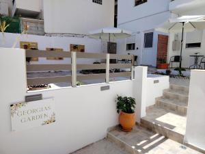 a white wall with a sign that says crocus garden at Georgia's garden 2 in Sitia