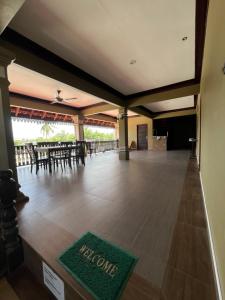 a banquet hall with a welcome mat on the floor at RAZAK GUEST HOUSE in Setiu