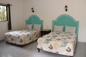 Letto o letti in una camera di Posada Ya´ax Ich
