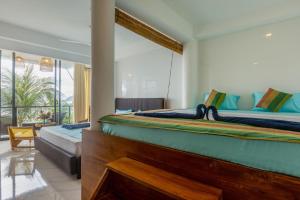 Postel nebo postele na pokoji v ubytování Peacock Beach Hotel Unawatuna