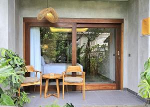 ウブドにあるDhanyasari Houseのパティオ(椅子2脚、テーブル、窓付) +39枚の写真