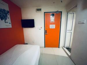 an orange door in a room with a bed at Sovotel @ Kota Damansara 8 in Kota Damansara +69 photos
