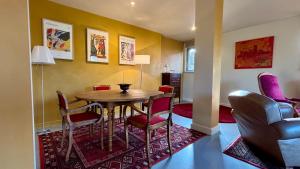 a dining room with a table and chairs at La maison de Crponne in Craponne