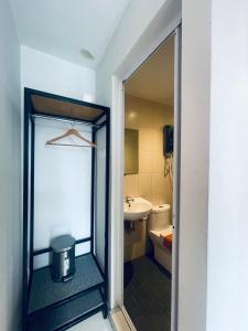 a bathroom with a mirror and a sink and a toilet at Sovotel @ Kota Damansara 8 in Kota Damansara