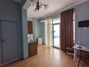 a living room with a hallway with a table and a door at Compass hotel in Kobuleti