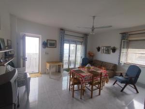 a living room with a table and chairs at Villa Sole e Mare in Villa San Giovanni