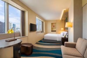 a hotel room with a bed and a window at Radisson Collection Hyland Shanghai in Shanghai