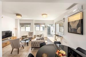 a living room with a couch and a table at Villa Antonieta in Ayia Napa