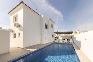 a swimming pool in the backyard of a house at Villa Antonieta in Ayia Napa