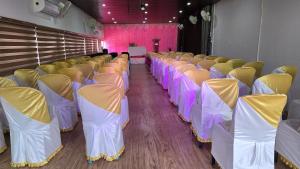 a row of chairs in a room with pink and purple at Bell Farms and Resorts in Munroe Island