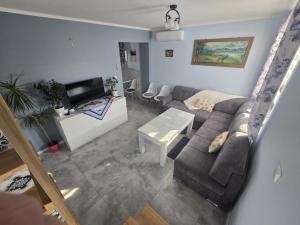 a living room with a couch and a table at Apartament Kristel Zator in Podolsze