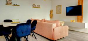 a living room with a couch and a table at Apartman Vrućica view in Teslić