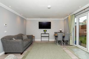a living room with a couch and a table at 3 Bedroom House-Private Parking in Bonnyrigg