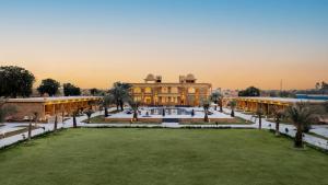a large building with a lawn in front of it at Sterling Rudraksh Jaisalmer in Jaisalmer