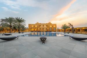 a resort with a pool in front of a building at Sterling Rudraksh Jaisalmer in Jaisalmer