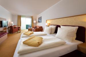 ein Hotelzimmer mit zwei Betten und Kissen darauf in der Unterkunft Hotel Sonnengut Wellness - Therme - Spa in Bad Birnbach + 46 Fotos