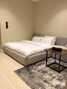 a bedroom with a bed and a coffee table at Studio Sulimaniyah in Riyadh