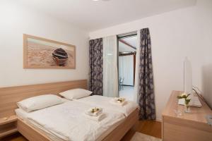 a bedroom with a bed and a window at Luxury Beachfront Villa Blue Star of Brac with private pool at the beach on Brac island - Bobovisca in Bobovišća