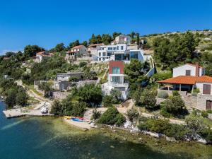 an image of a house on a hill next to the water at Luxury Beachfront Villa Blue Star of Brac with private pool at the beach on Brac island - Bobovisca in Bobovišća