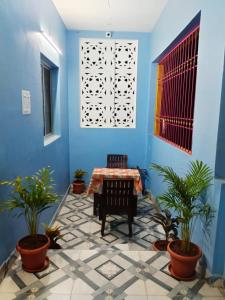 a blue room with a table and potted plants at Paradise sunrise villa in Puducherry