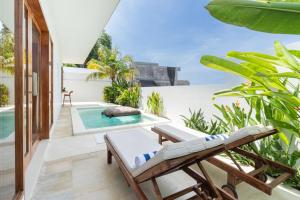 an outdoor patio with a pool and a chaise lounge at Salthouse Villa Uluwatu in Uluwatu +36 photos
