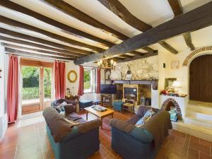 a living room with couches and a fireplace at Séjour authentique-Piscine Privée Chauffée- Spa et Nature in Beauville